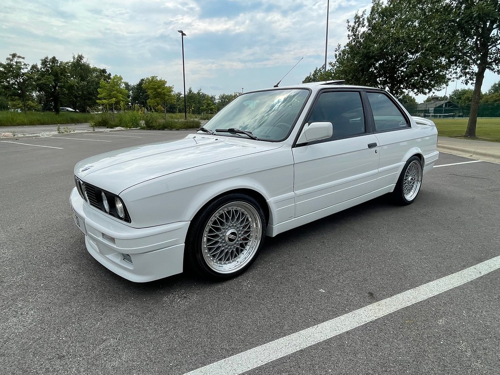 After: restored white BMW E30 325is with mesh wheels and body-color trim